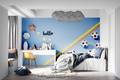 Football wallpaper in modern teen bedroom showing vibrant blue design with rainbow accents