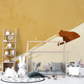 Forest animal wallpaper in modern nursery showing brown bear mural creating cozy reading nook