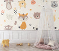 Forest animals wallpaper in bright nursery with white crib and natural decor