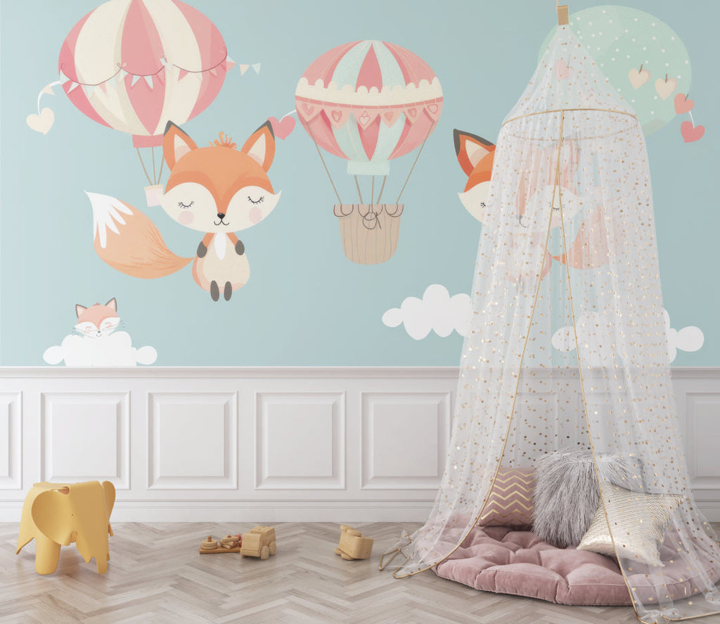 Kids room wall mural featuring fox and balloons, styled with white furniture and pink accents
