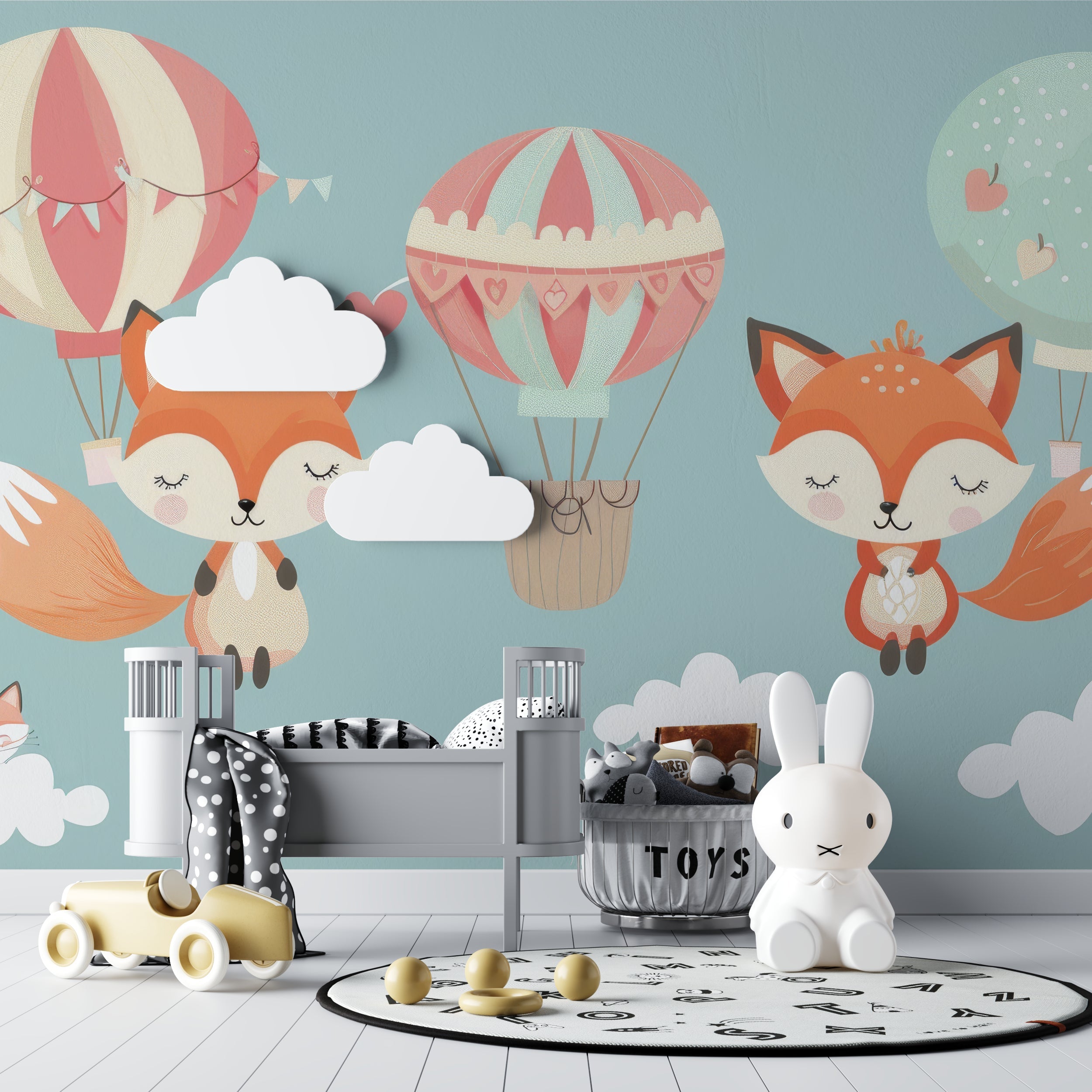 Forest animals wallpaper in baby room with crib and mobile, showing dreamy balloon scene