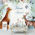 Forest animals wallpaper creating a cozy atmosphere in a modern nursery with white furniture