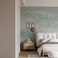 Misty forest wallpaper in modern living room, creating depth with soft mountain landscape and morning fog