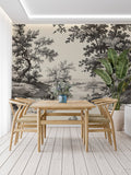 Black and white forest mural wallpaper creating depth in modern living room with grey sofa