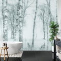 Black and white forest wallpaper creating depth in modern living room with minimal furniture