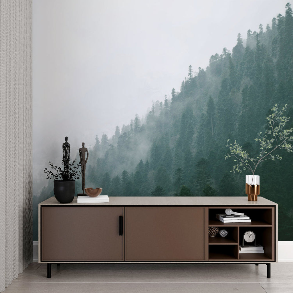 Misty pine forest wallpaper in cozy bedroom setting with minimal furniture