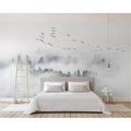 Misty forest wallpaper creating depth in a modern bedroom, morning light filtering through the pine trees and birds