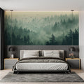 Forest wallpaper mural creating depth in modern living room, morning light filtering through misty pines