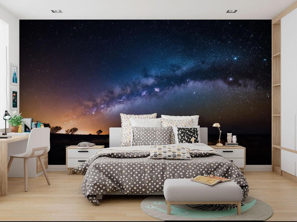 Milky Way wallpaper adding drama to a teen's gaming room setup