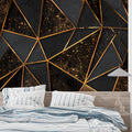 3D geometric black and gold cube wallpaper in a modern living room with leather furniture