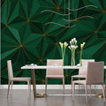 Green and gold geometric wallpaper creating depth in a modern living room with minimal furniture