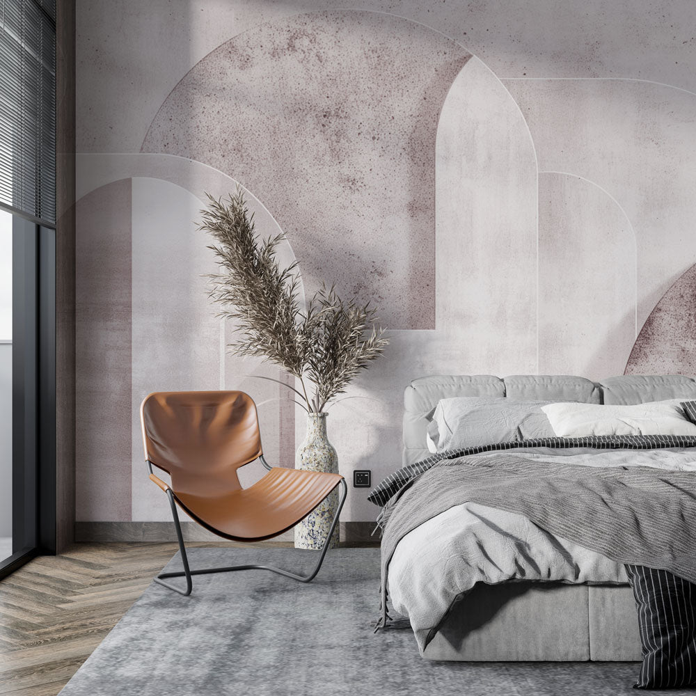 Pink geometric arch wallpaper creating an elegant backdrop in a modern living room with curved furniture and soft lighting