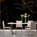 Geometric black and gold wallpaper creating drama in a modern living room with clean lines and contemporary furniture
