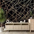 Black and gold geometric wallpaper creating modern elegance in a luxury dining room with pendant lighting
