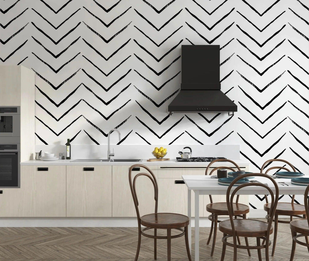 Modern black and white geometric wallpaper creating depth in a minimalist living room setting