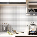 Modern black and white grid wallpaper in a minimalist home office with natural light and simple furniture