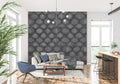 Black geometric Art Deco wallpaper in modern living room with grey sofa and minimalist decor