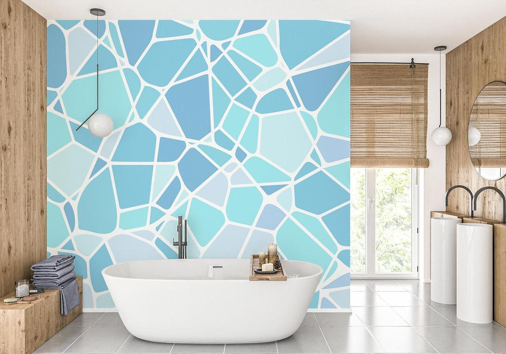 Modern blue geometric wallpaper creating depth in a minimalist living room with natural lighting