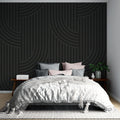 Modern geometric wallpaper with black curved lines creating depth in a minimalist living room setting