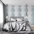 Modern blue circle wallpaper in a bright Scandinavian living room, showing geometric pattern flow