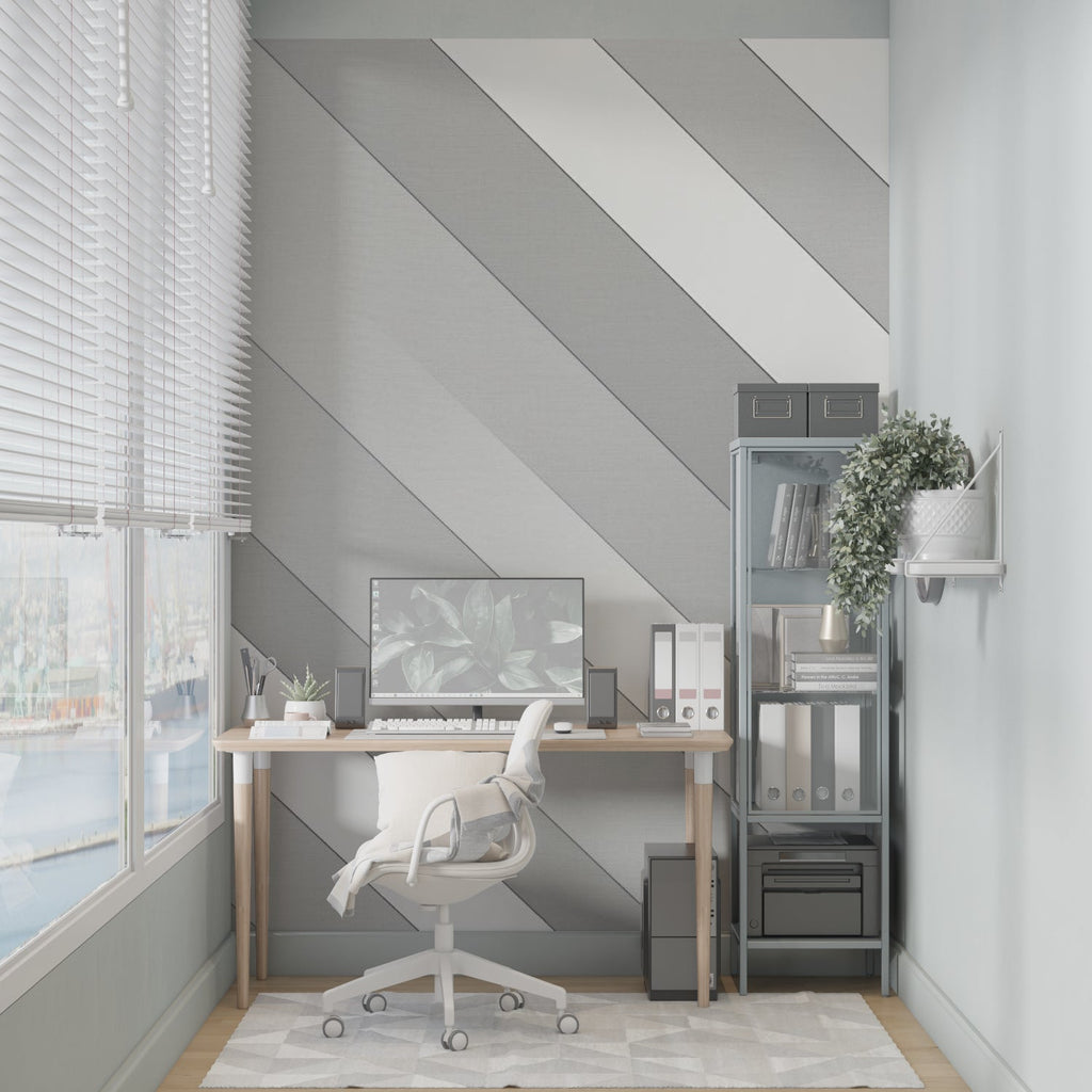 Diagonal stripe wallpaper creating depth in a contemporary living room with grey furniture