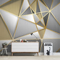 Modern geometric wallpaper with gold lines in a bright living room setting showing depth and luxury