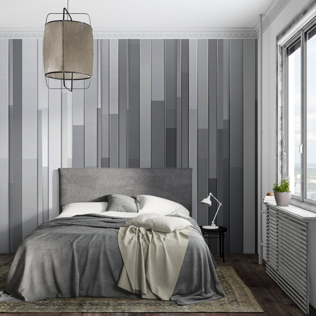 Modern grey stripe wallpaper in a minimalist living room with natural light highlighting the gradient pattern