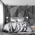 Modern geometric wood wallpaper in minimalist living room with grey sofa and natural lighting