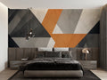 Modern geometric wallpaper in stylish living room with grey sofa and orange accents