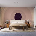 Modern purple geometric wallpaper in a minimalist living room with grey sofa and natural light