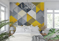 Modern geometric yellow and grey wallpaper in a bright living room setting with minimal furniture