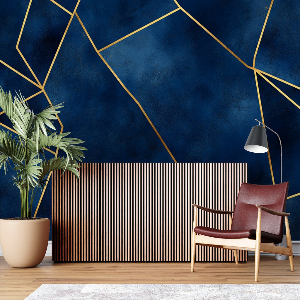 Geometric navy and gold wallpaper in modern living room setting with clean furniture and natural light