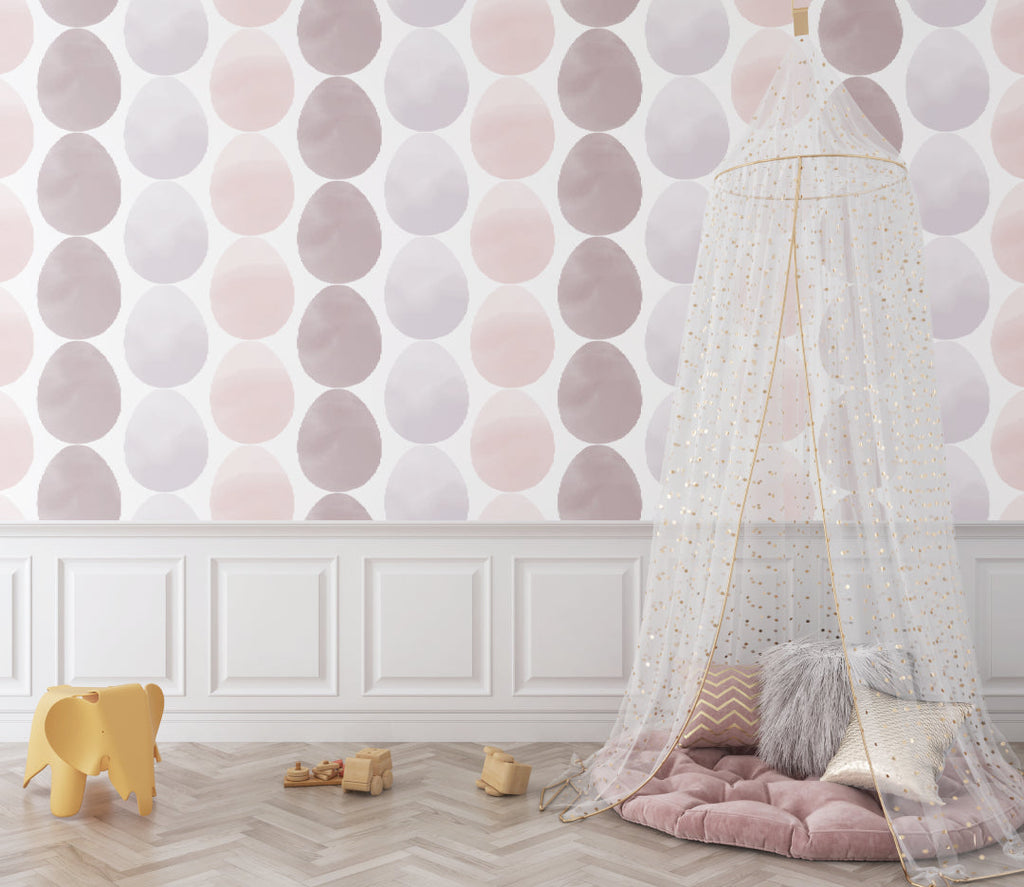 Geometric circle pattern wallpaper in girl's bedroom with pink accents and natural light