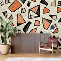 Geometric abstract wallpaper in modern living room showing terracotta and black shapes creating depth