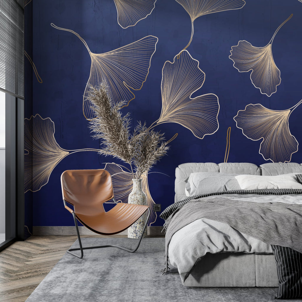 Gold Ginkgo leaf wallpaper in modern living room with gray sofa and brass accents