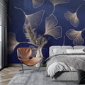 Gold Ginkgo leaf wallpaper in modern living room with gray sofa and brass accents