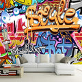 Graffiti wallpaper bringing urban style to a modern living room with bold orange and blue street art design