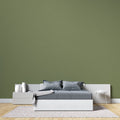Modern green wall mural in bright living room showing peaceful khaki tones