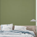 Modern olive green wallpaper in bright living room with minimalist furniture