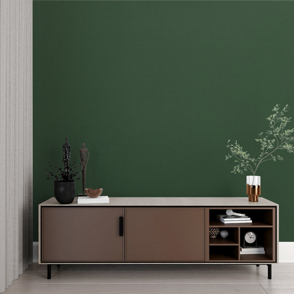 Solid green wall mural in a home office with wooden desk and natural light