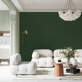 Modern emerald green wallpaper in a bright living room setting, showing how the solid color creates depth