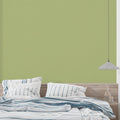 Green bamboo wallpaper creating a serene atmosphere in a modern living room with natural light