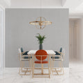 Modern grey wallpaper mural in bright living room with minimal furniture and large windows