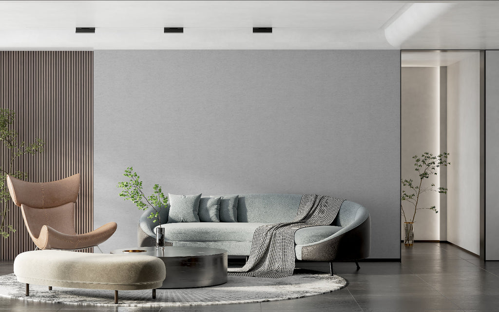 Modern grey textured wallpaper in a minimalist living room setting with natural light
