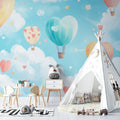 Hot air balloon wallpaper creating a magical atmosphere in a bright nursery with white furniture