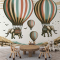 Hot air balloon wallpaper with flying elephants creating a magical atmosphere in a bright nursery with reading nook