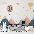 Hot air balloon nursery wallpaper creates dreamy atmosphere in modern Scandinavian nursery with white furniture