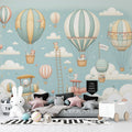 Hot air balloon nursery wallpaper with teddy bears creates a dreamy atmosphere in a modern white and gray nursery with rocking chair