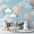Hot air balloon nursery wallpaper in a modern white nursery, creating a soft and dreamy atmosphere