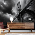 Black and white industrial windmill wallpaper creating dramatic impact in a modern office space with minimal furniture